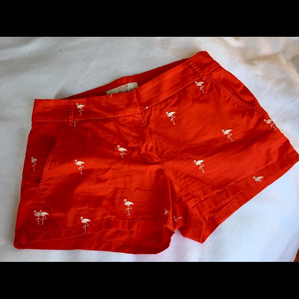Orange J. Crew shorts with embroidered flamingos
